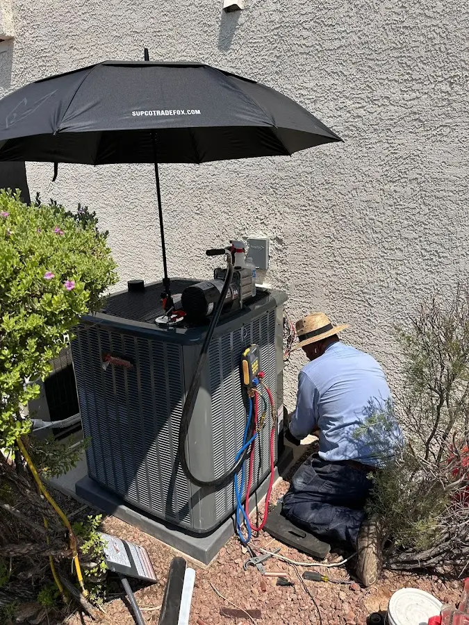 HVAC technician performing outdoor AC maintenance in Buckhead