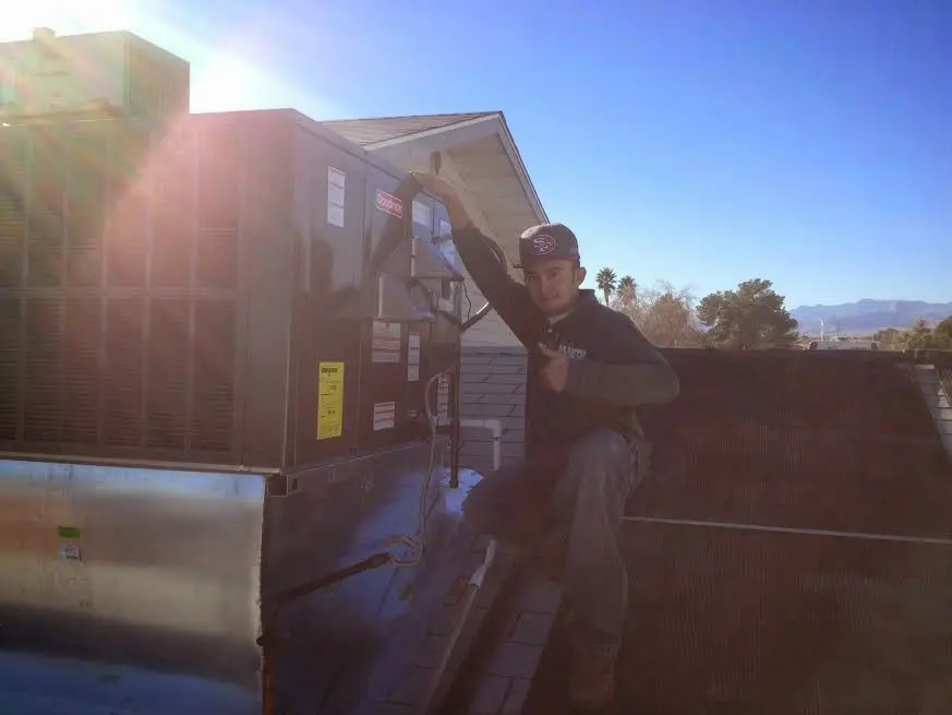 HVAC technician performing HVAC Inspection on a rooftop unit in Buckhead